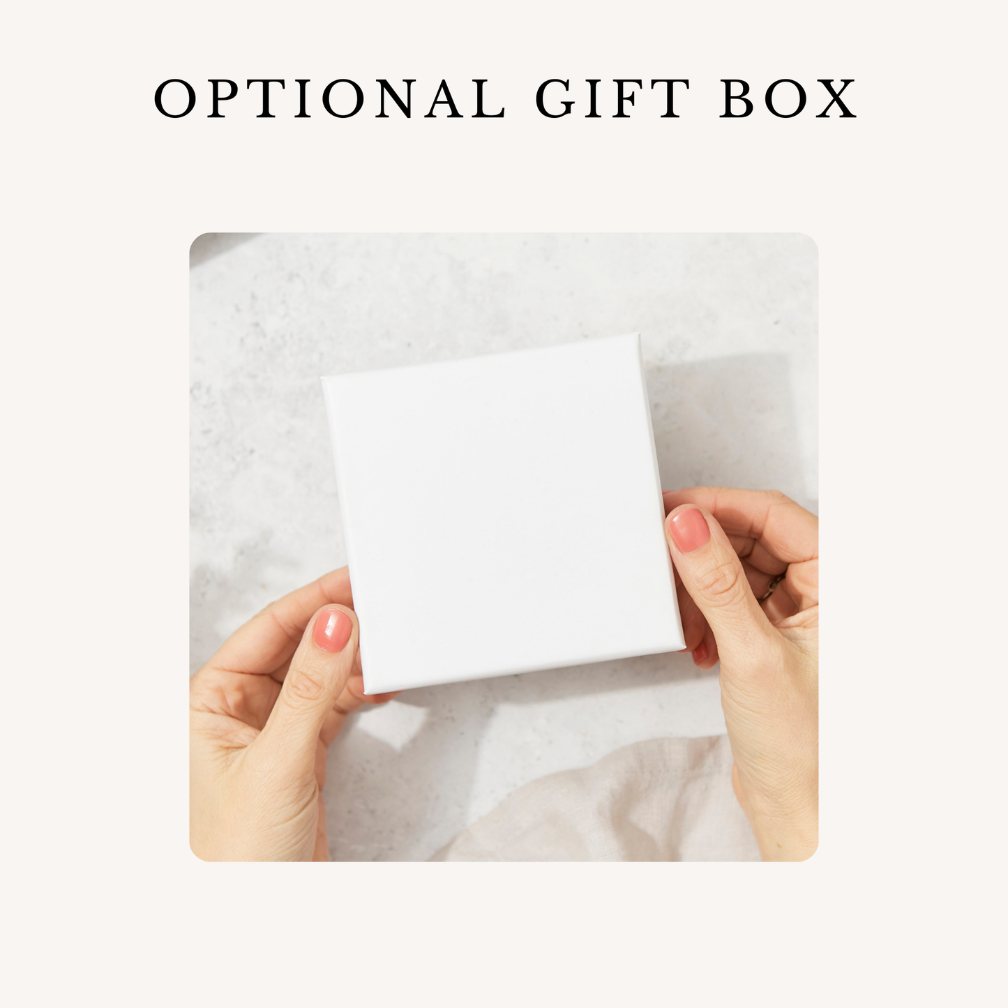 a woman's hands holding a white gift box