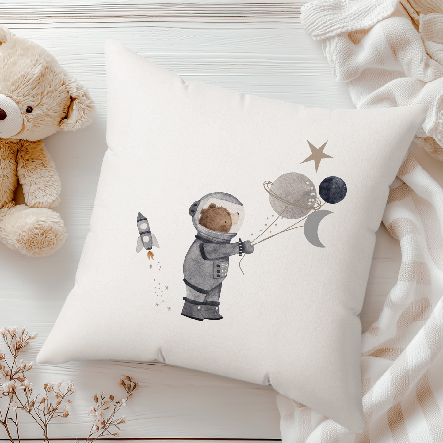 white cushion with a space bear astronaut with planets and stars and rocket illustration