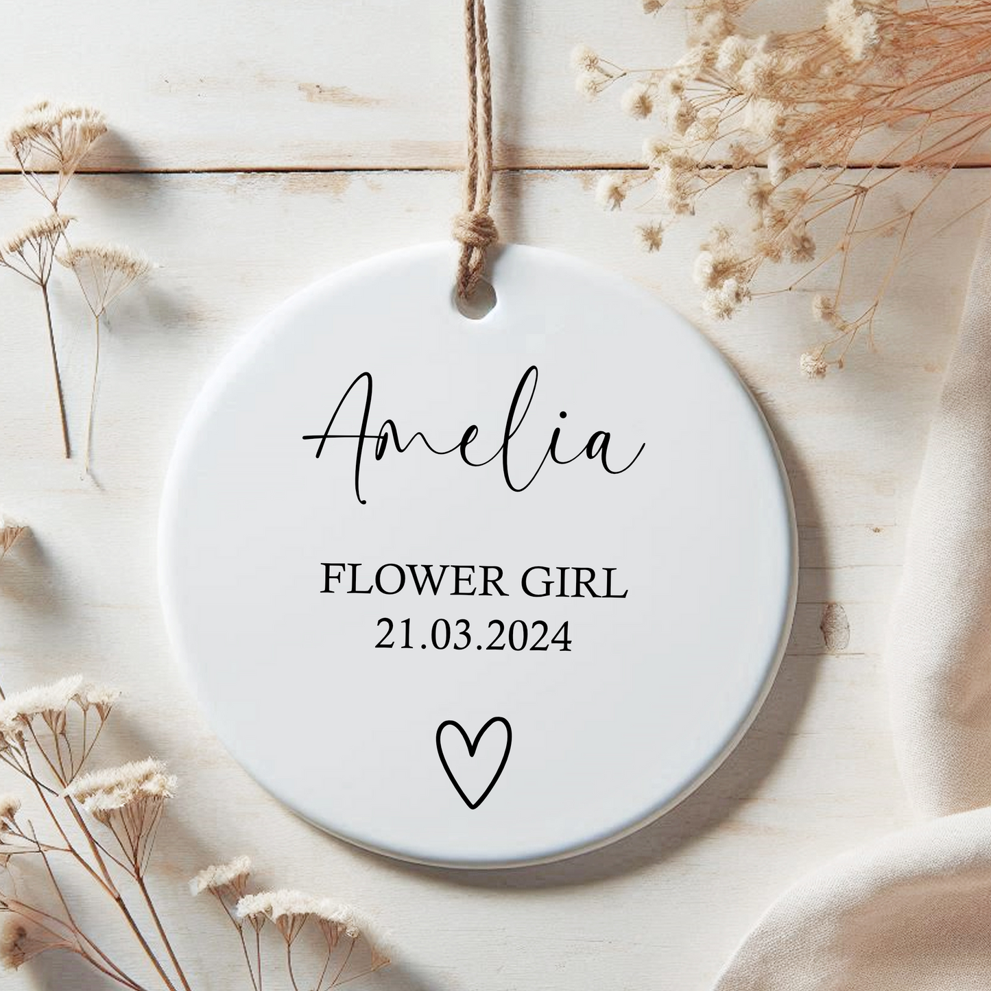 a personalised ceramic ornament for flower girl with a heart on it