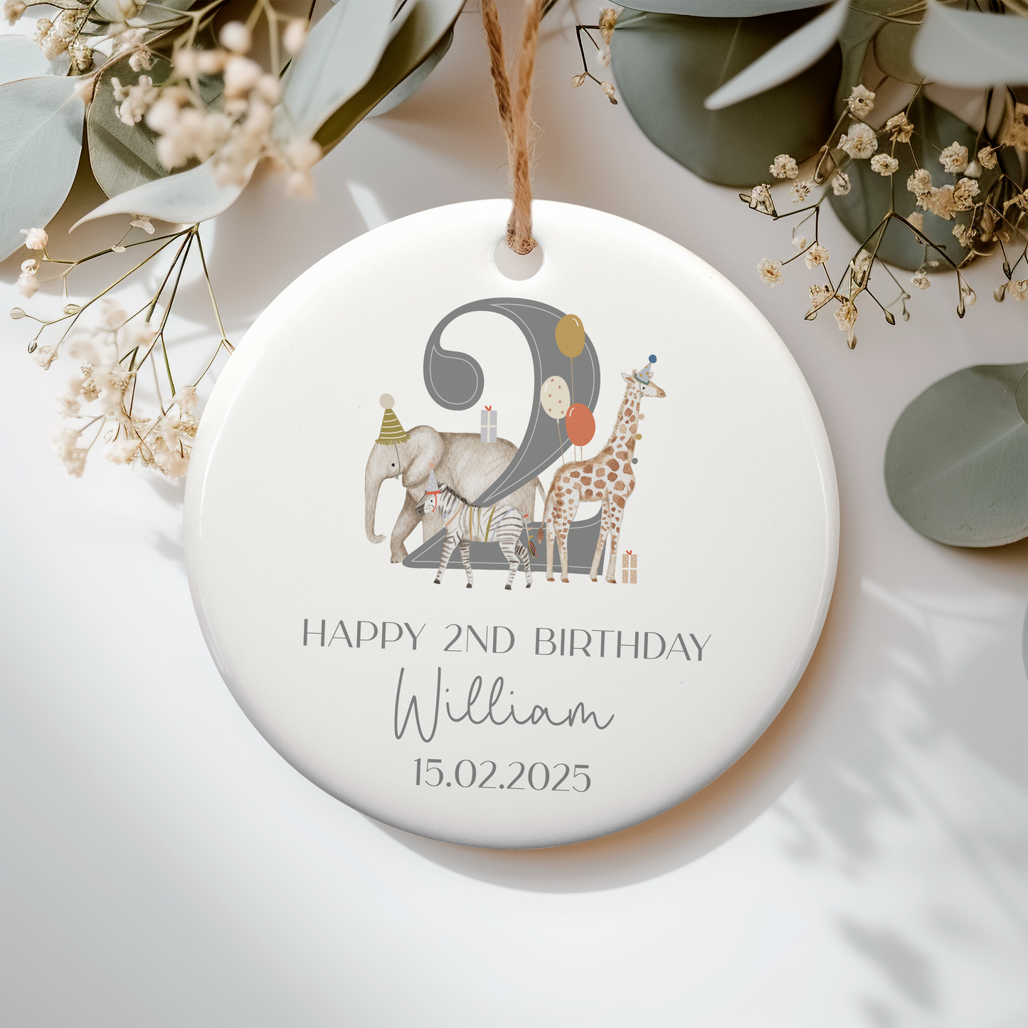 a personalized ceramic ornament with an elephant, giraffe and safari animals. Grey number 2 , personalised with name and date