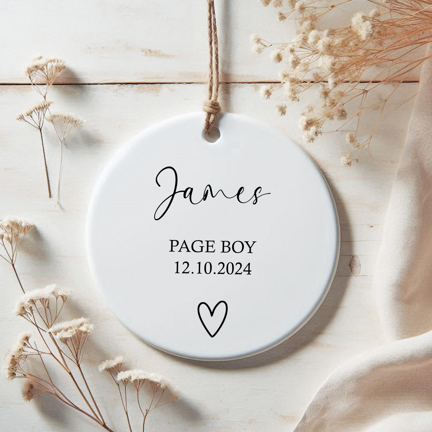 a personalised page boy ornament with a heart on it