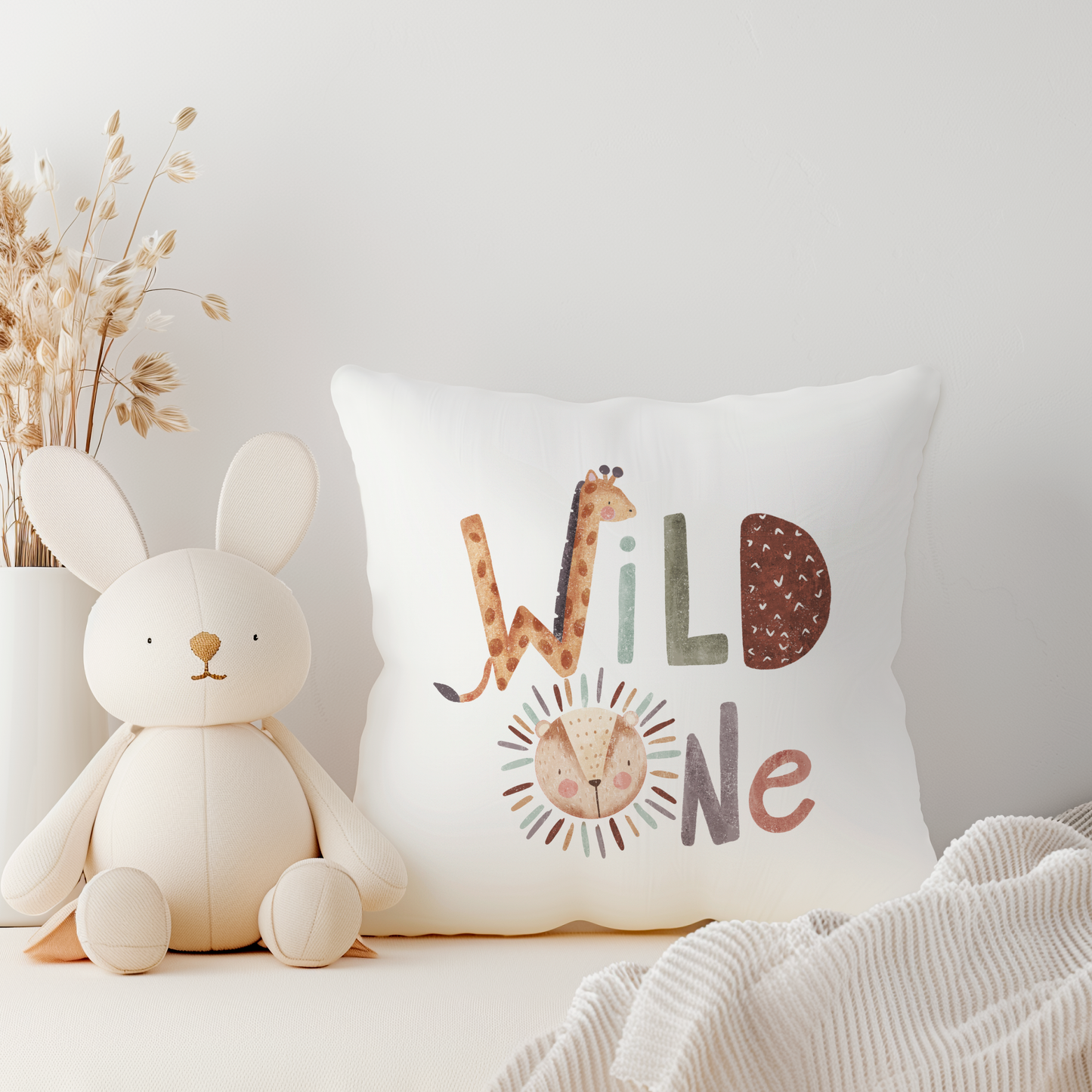 White cushion with wild one text incorporating giraffe and lion