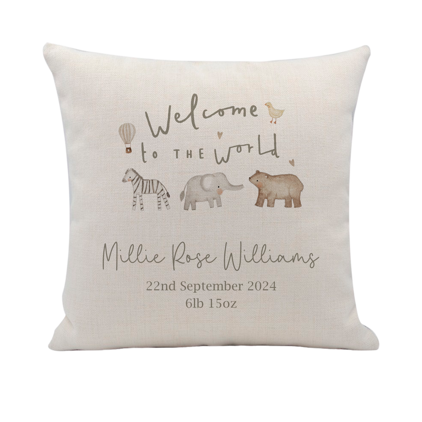 a white pillow with an elephant and giraffe on it