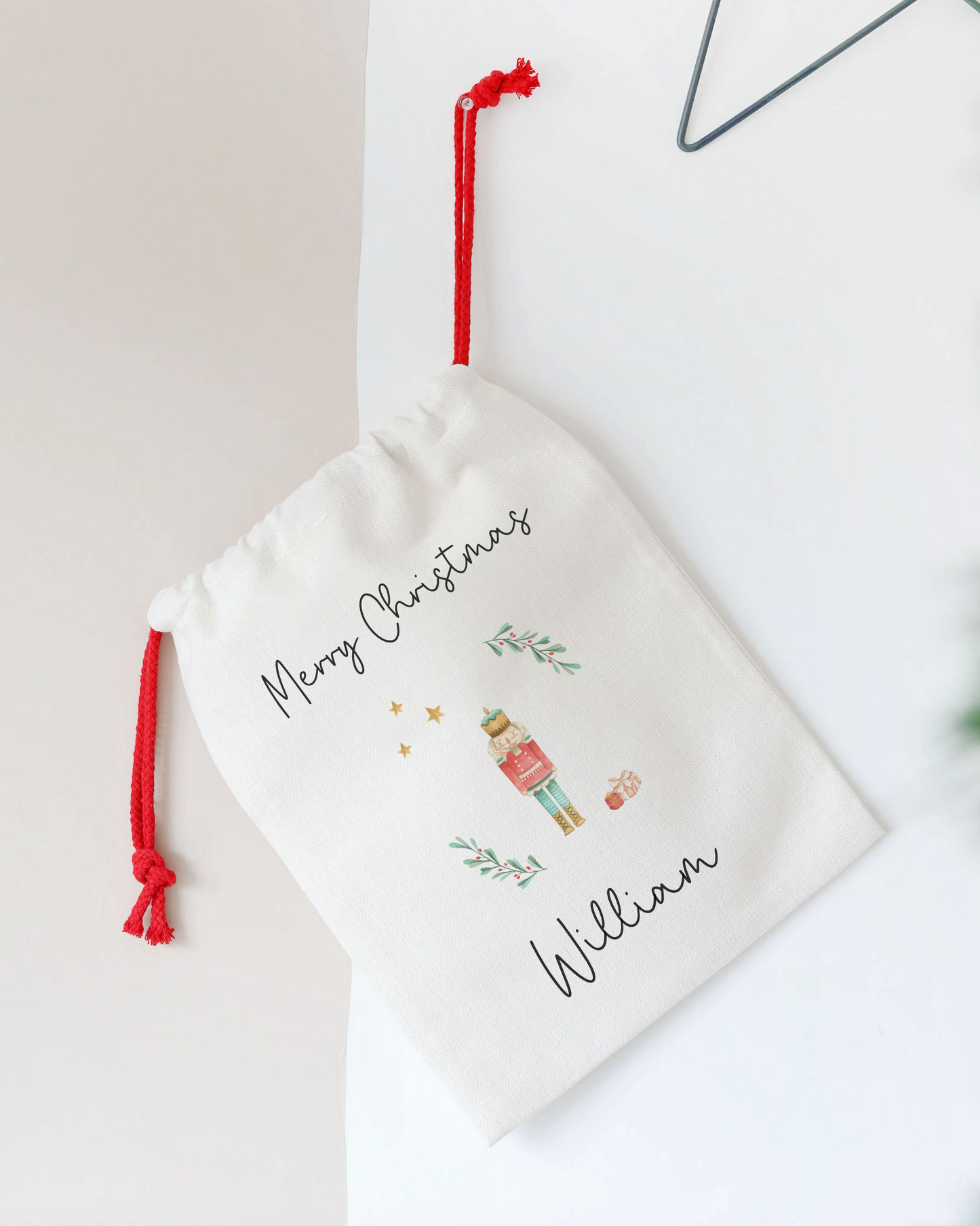 Personalized Christmas stocking with red drawstring on a white background