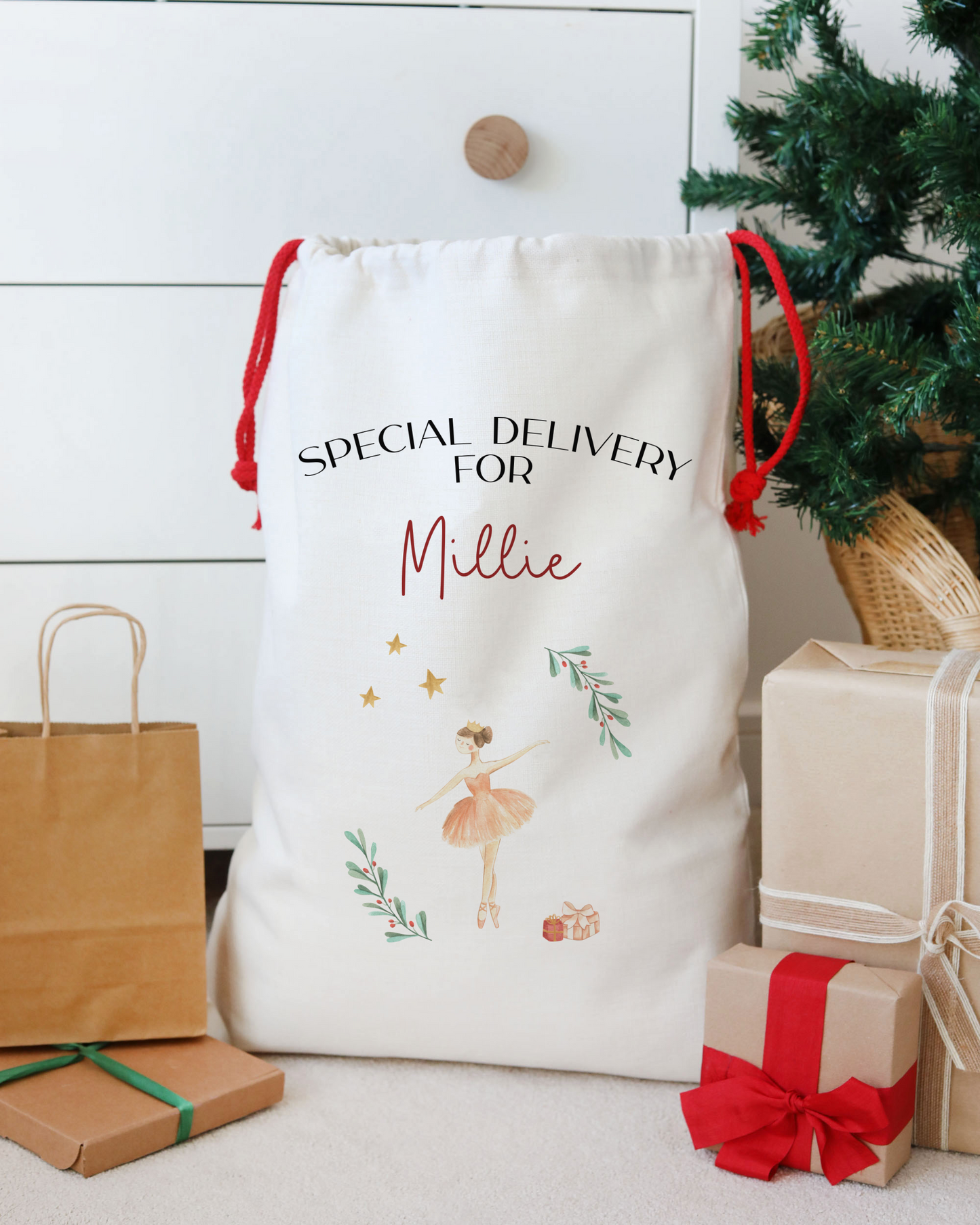 Personalized gift bag with text and graphics, surrounded by Christmas presents and a tree.