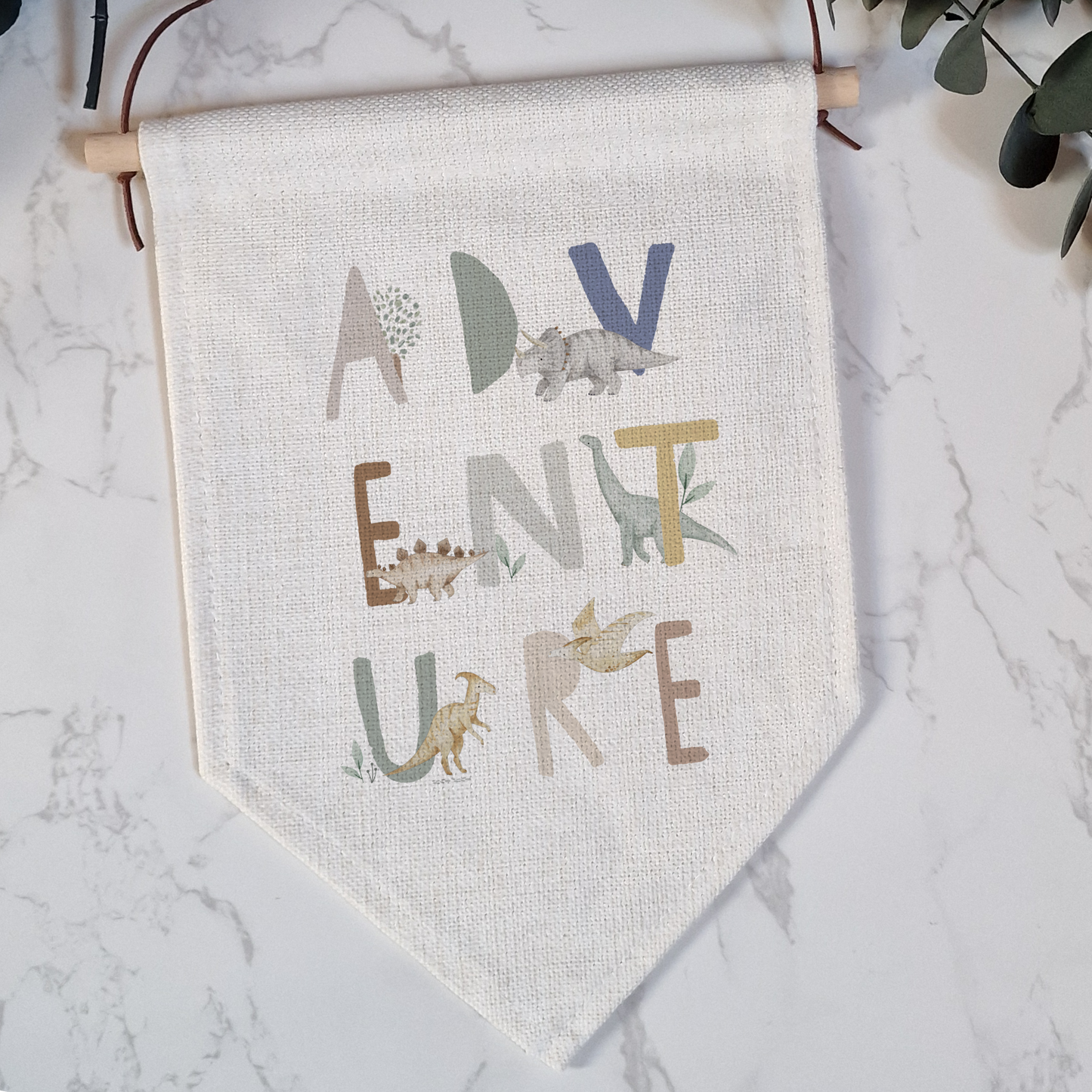 a wall hanging with a plant and a banner