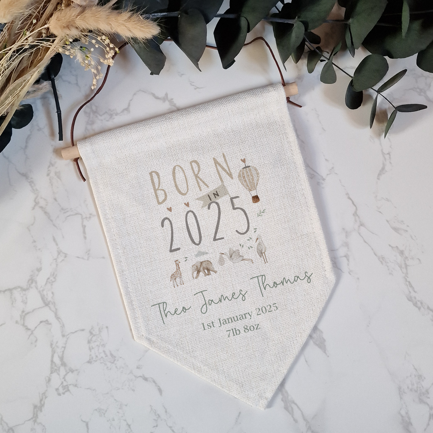 Off white linen like nursery pennant flag. Born in 2025 text with jungle safari animal illustrations. Personalised with name, birth date and weight.