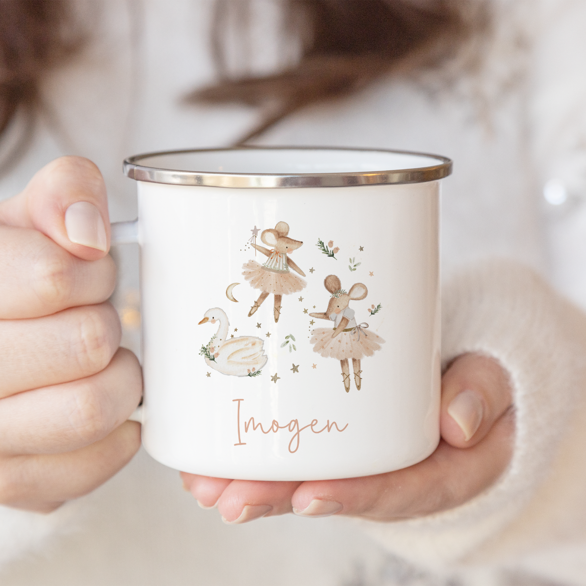 Person holding a mug with name and festive mice and swan illustration