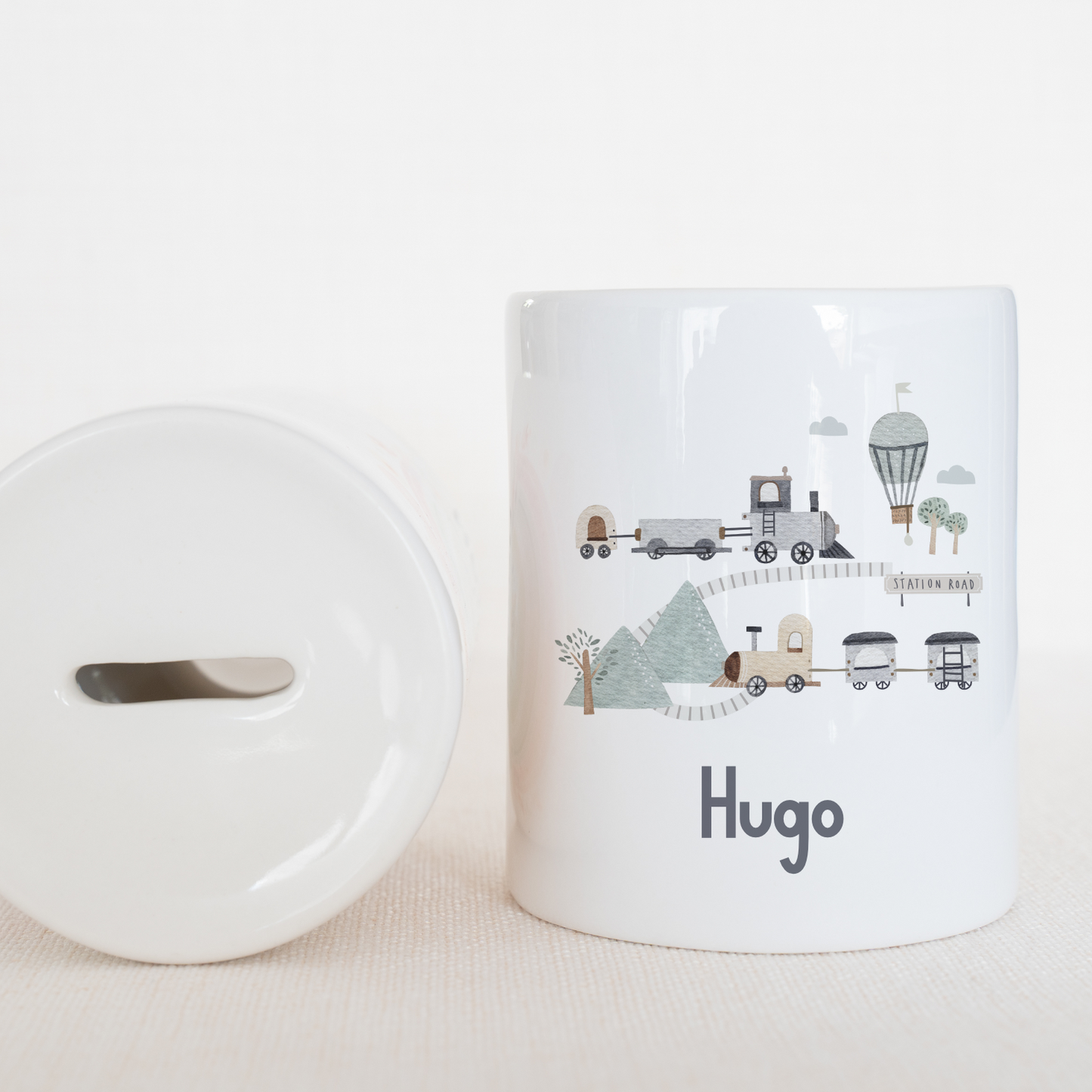 a white coffee mug next to a white lid