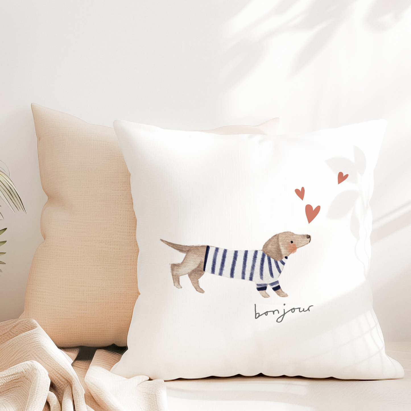 White canvas pillow with cute Dachshund puppy with hearts and bonjour text.