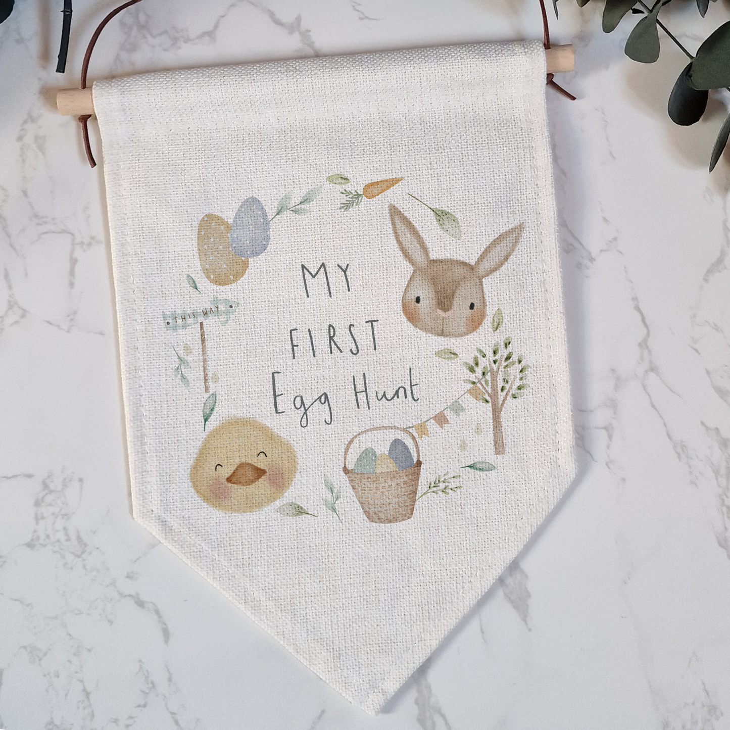 a cross stitch banner hanging on a wall