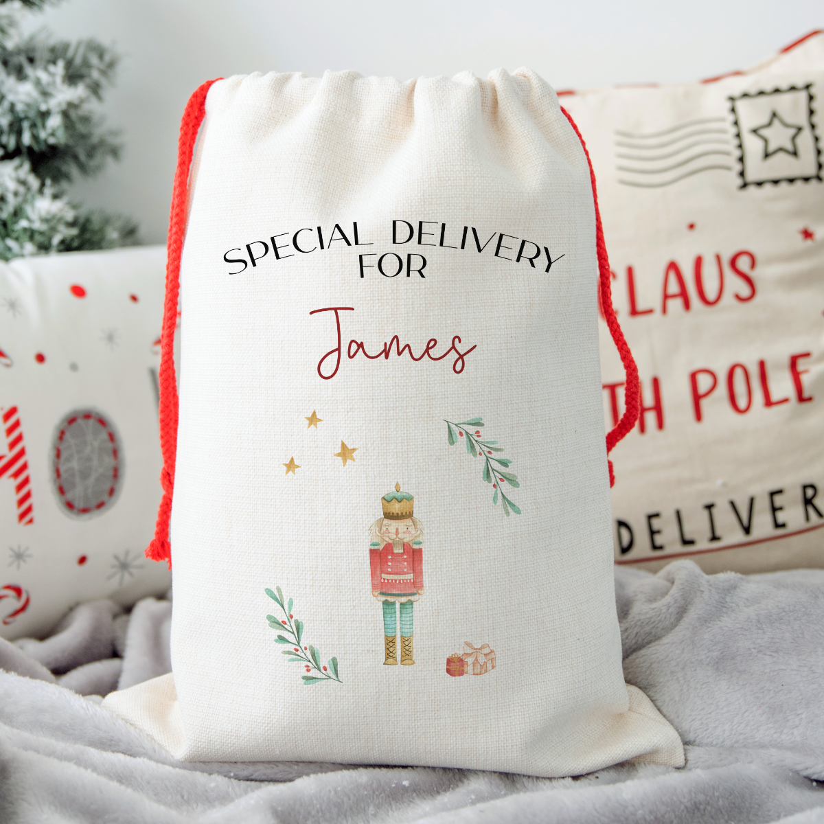 Personalized Christmas gift bag with 'Special Delivery for James' text and festive design of the Nutcracker