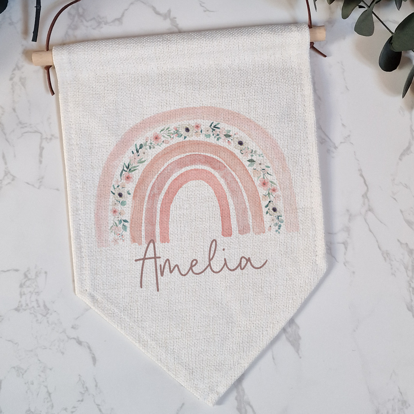 Off white linen like flag pennant, pink floral boho rainbow and personalised with name in script font.