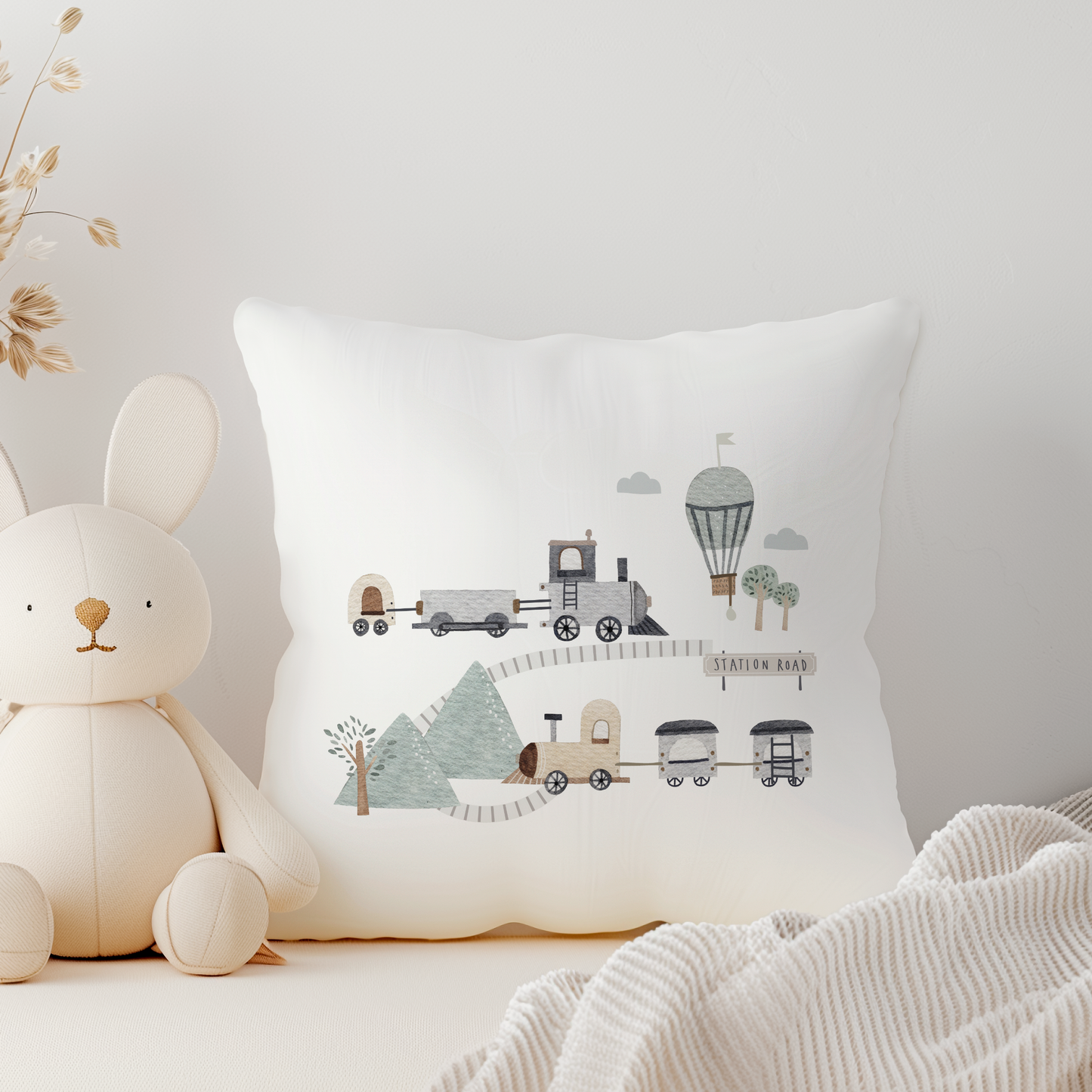 a white canvas cushion with train illustration