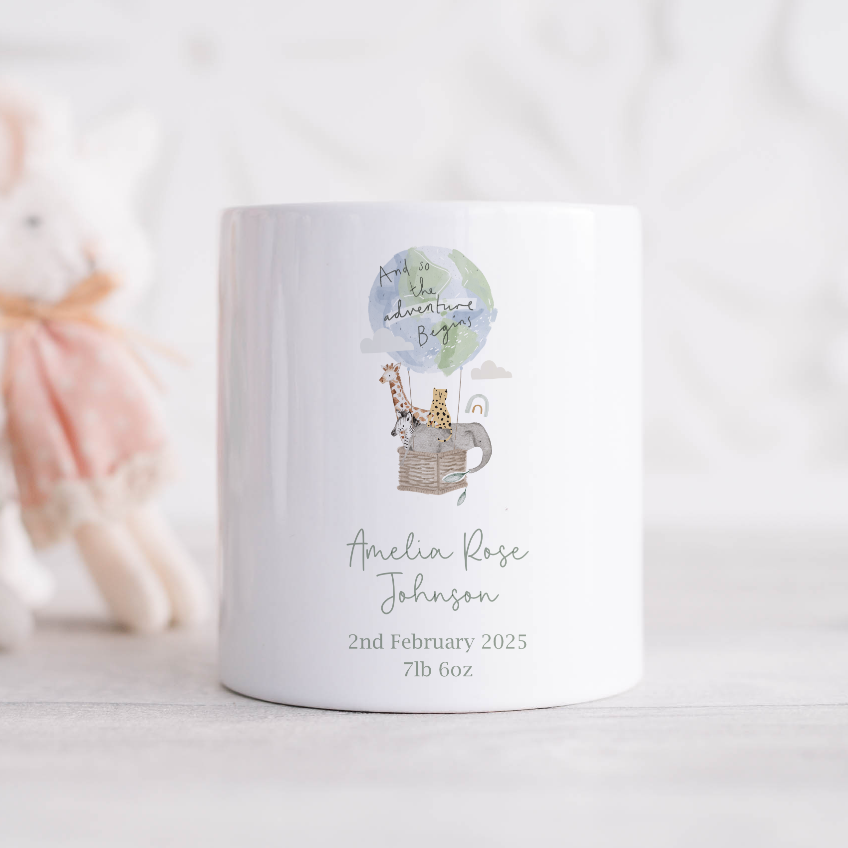 a white ceramic money box with a picture of a giraffe and jungle animals in a hot air balloon. Personalised with baby birth details
