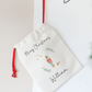 Personalized Christmas stocking with red drawstring on a white background