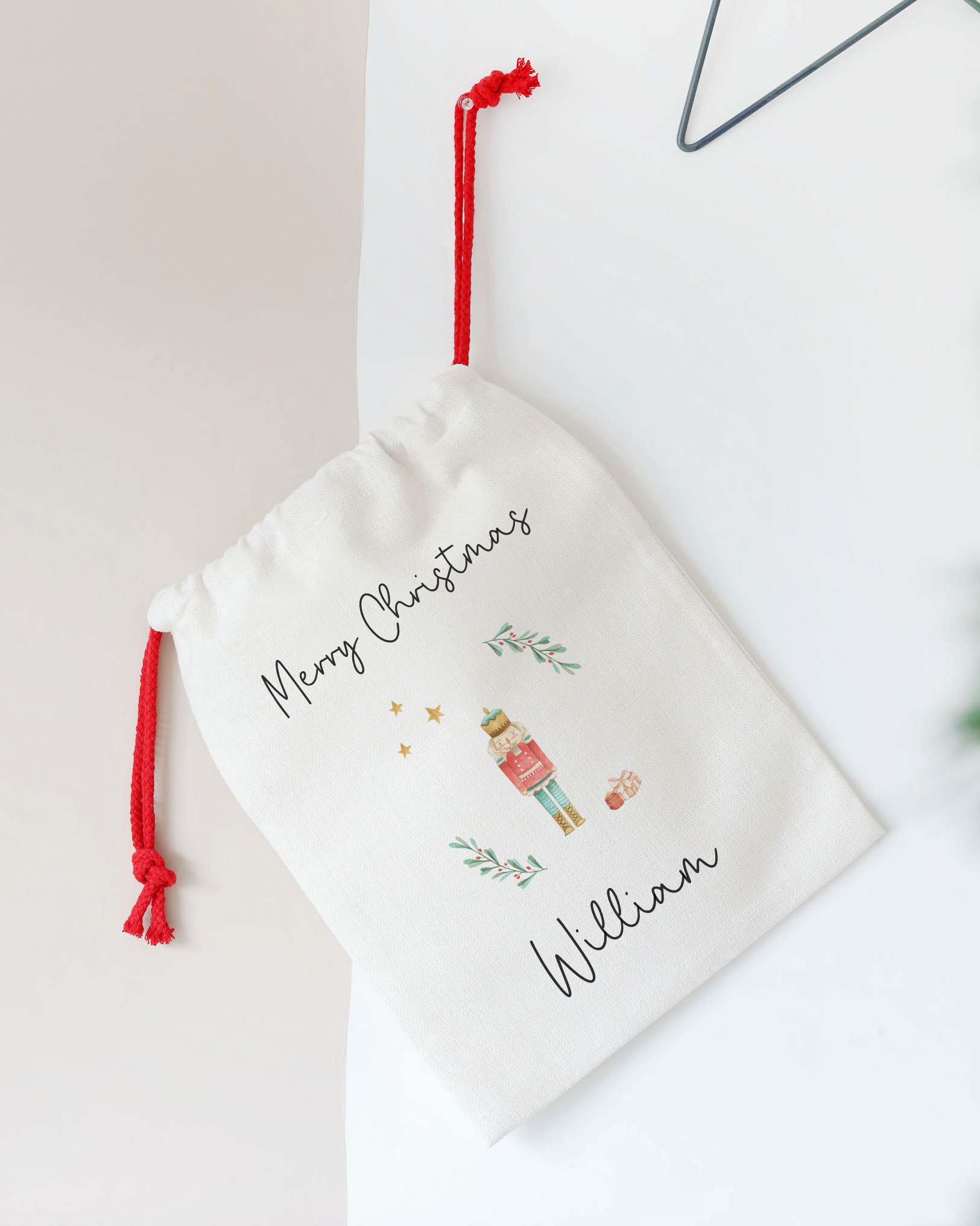 Personalized Christmas stocking with red drawstring on a white background