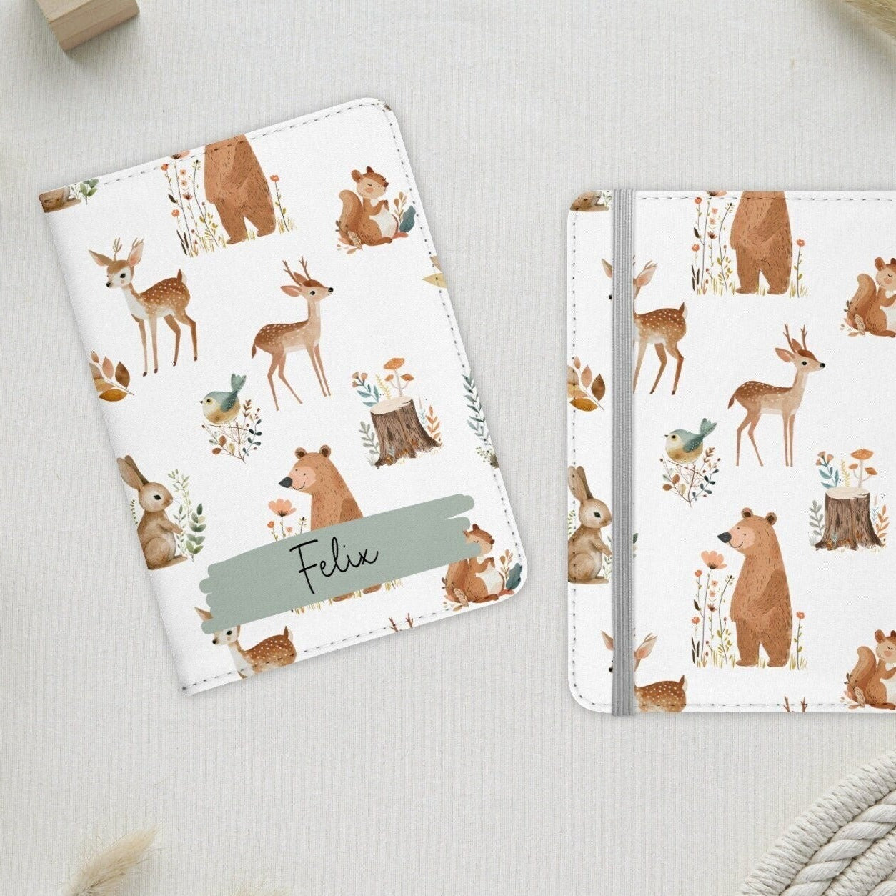 White passport holder with cute woodland animals, personalised with name in green banner