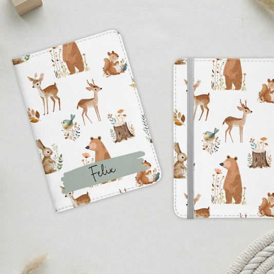 White passport holder with cute woodland animals, personalised with name in green banner