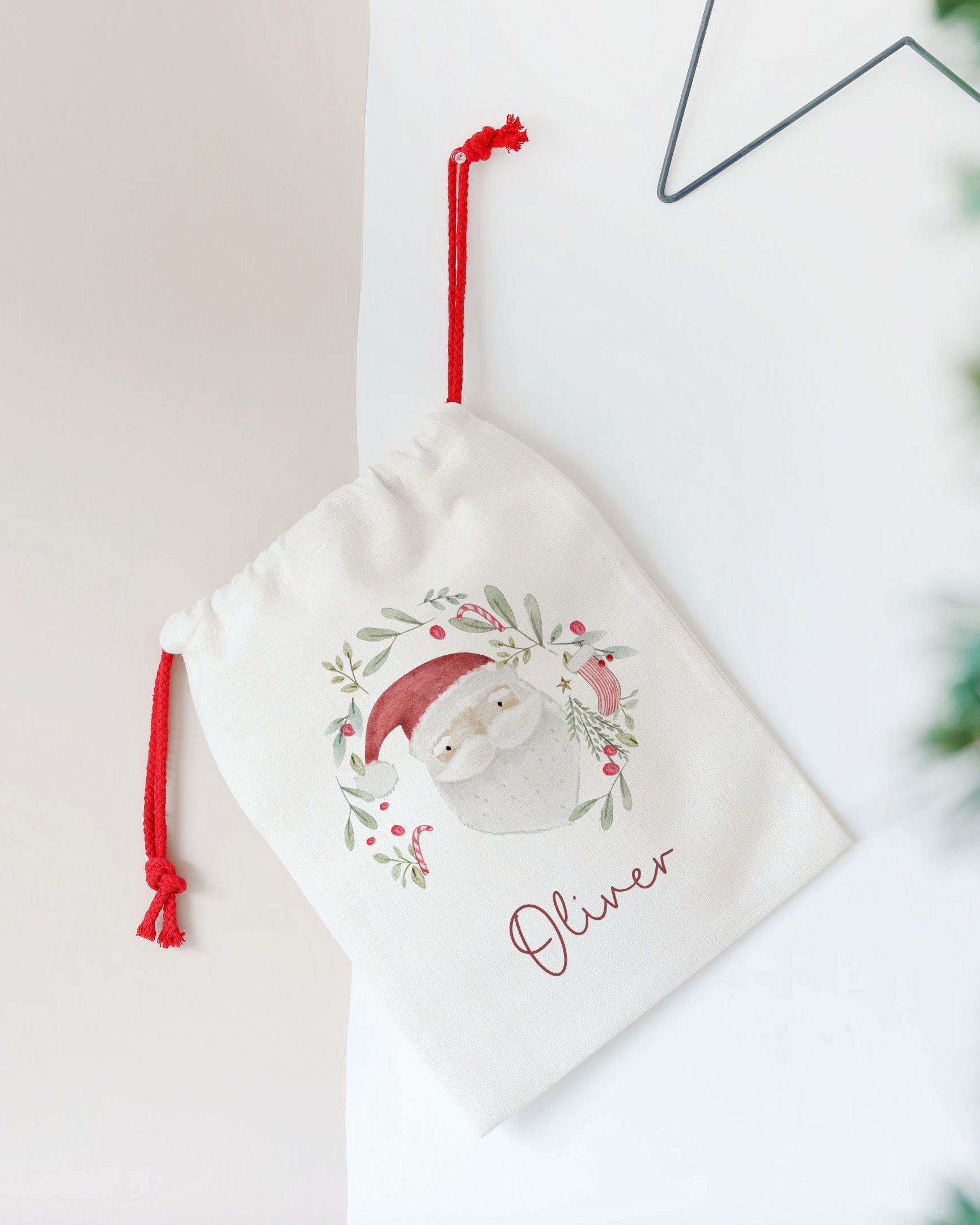 Decorative pouch with a festive design and name 'Oliver' on a light background