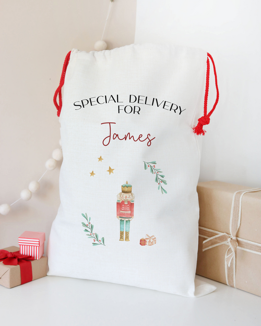 Personalized Christmas gift sack with a nutcracker design and text on a white background.