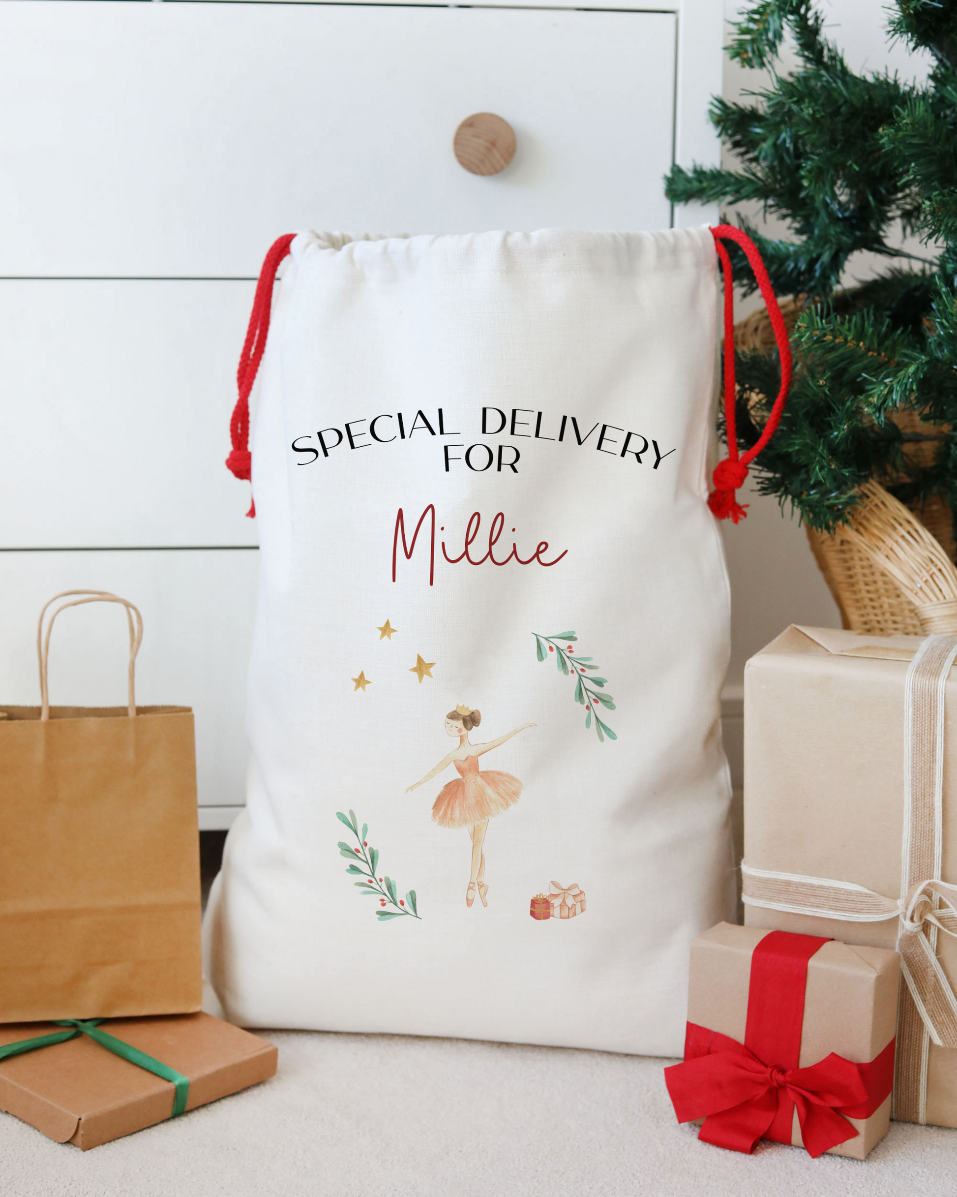 Personalized gift bag with text and graphics, surrounded by Christmas presents and a tree.