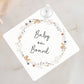 White plastic baby on board sign with wildflower wreath