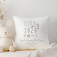 white pillow with born in 2024 text and hot air balloon illustration, personalised with name in green font.