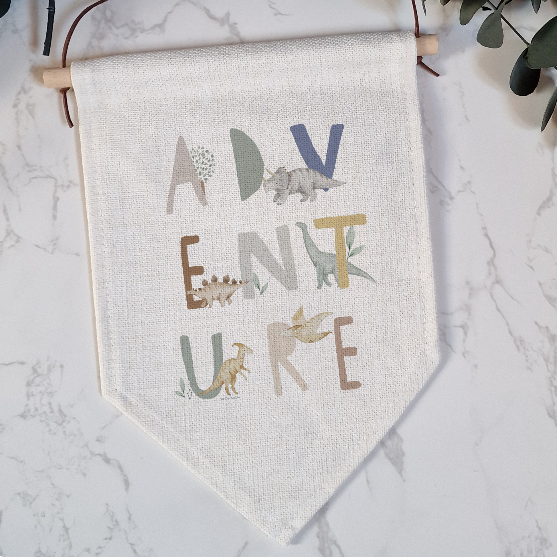 a wall hanging with a plant and a banner