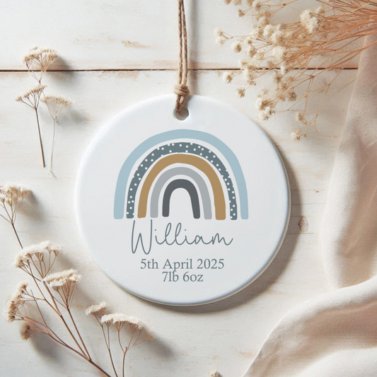 White ceramic ornament with blue rainbow, personalised with name and birth details