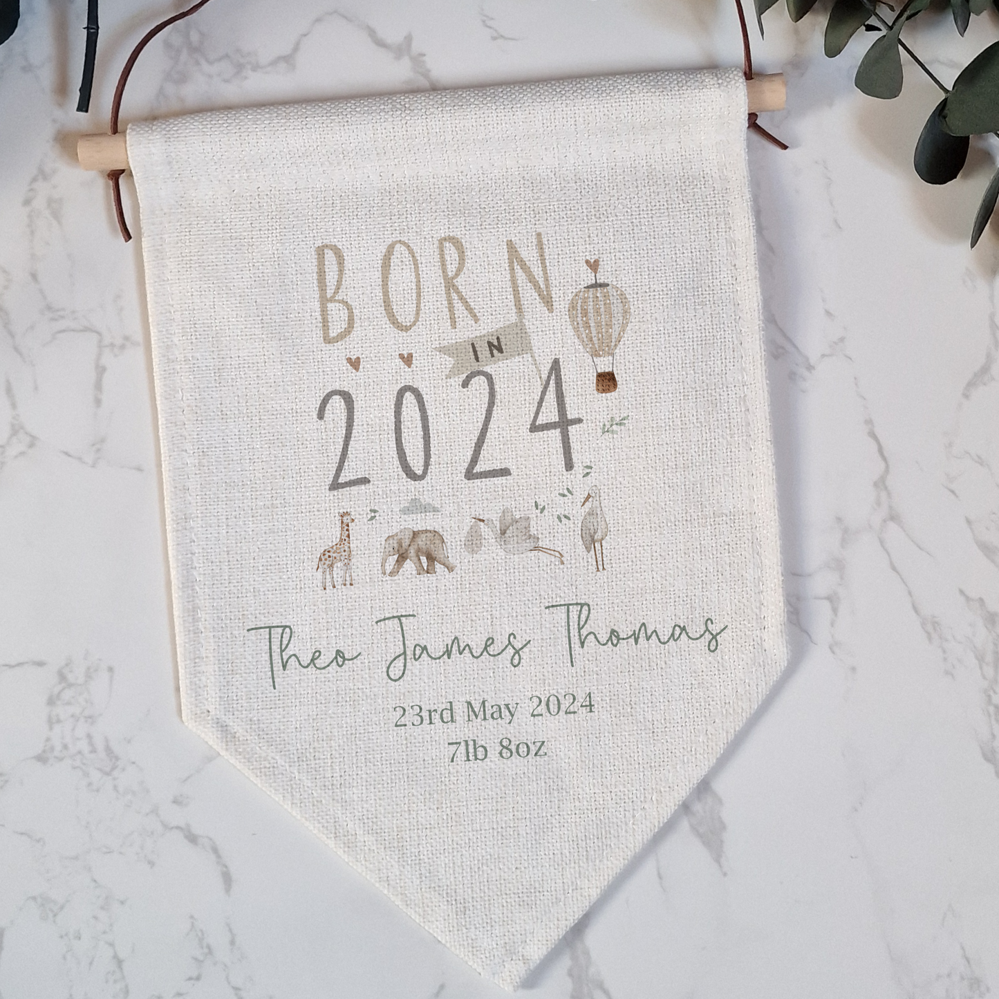 Linen flag with Born in 2024 text and safari animals. Personalised with name and birth details.