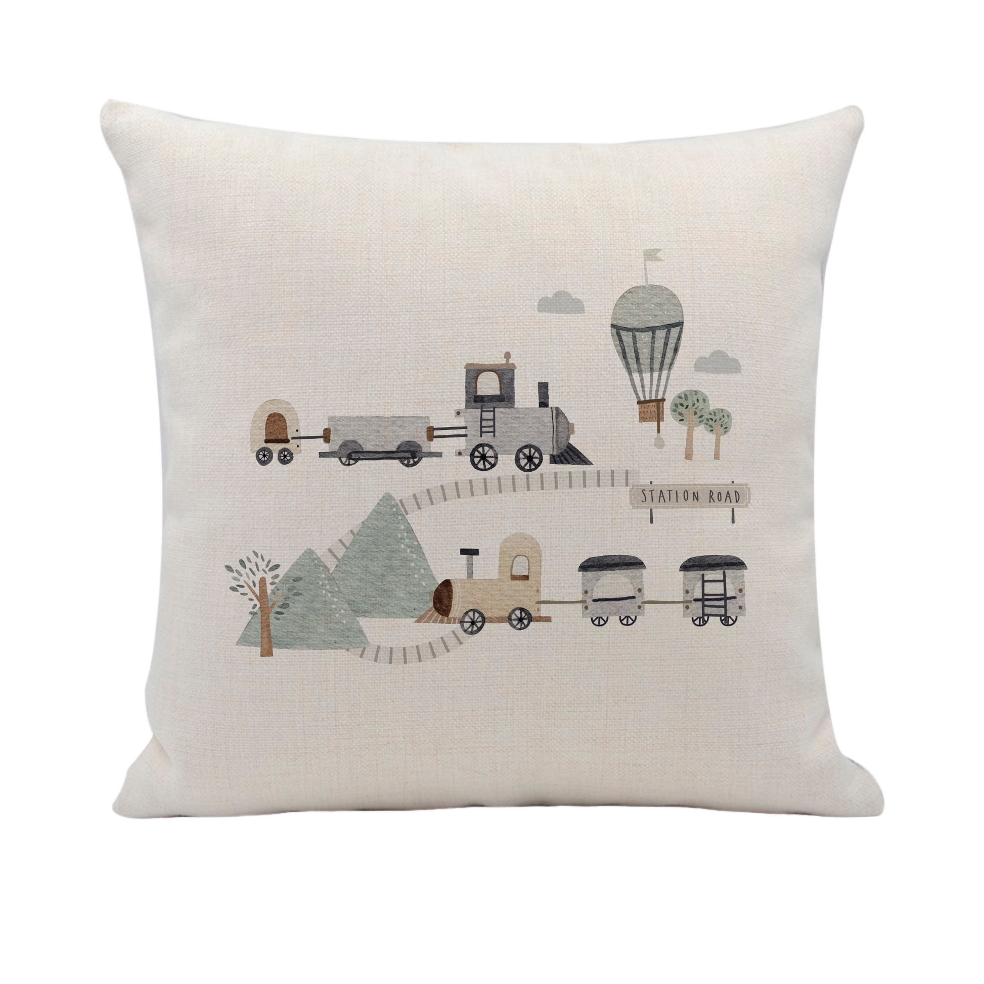 a white pillow with a train and trees on it