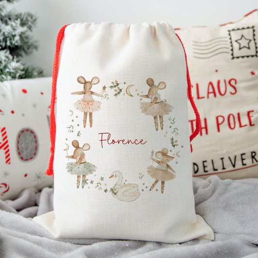 Off white linen santa sack with red drawstrings. Christmas mouse ballerina illustration wreath, personalised with name in the centre.