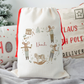 Decorative Christmas sack with festive nutcracker mouse design and personalised name on a soft surface.