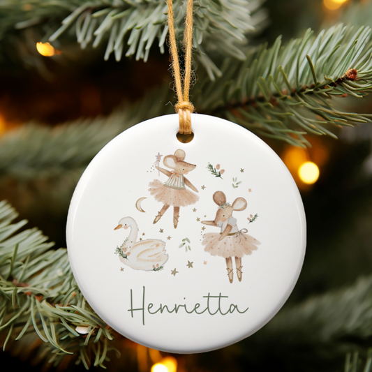 Decorative Christmas ornament with illustrations of a swan, and mouse on a tree branch.
