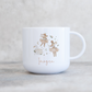 White mug with festive mice design and 'Imogen' text on a light background