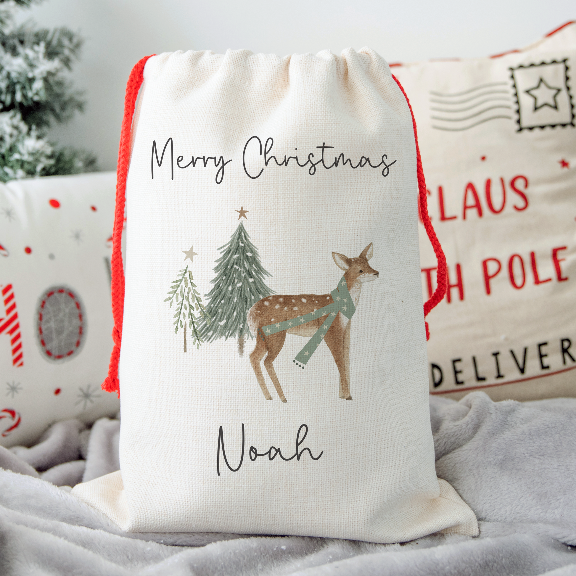 Off white linen santa sack with whimsical reindeer and christmas tree illustration. Personalised with name.