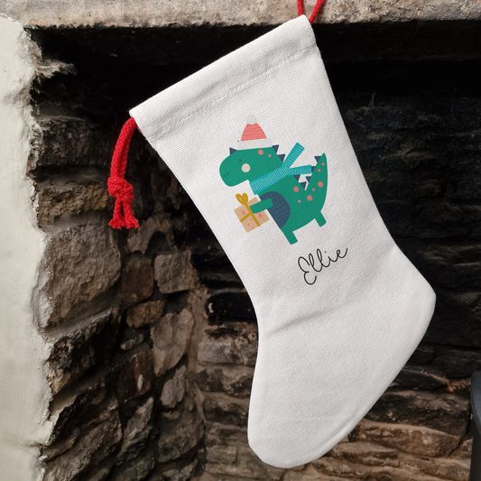 Off white linen-like stocking with festive dinosaur, personalised with name in black script font.