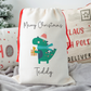 Off white linen-like santa sack with festive dinosaur. Personalised with name.