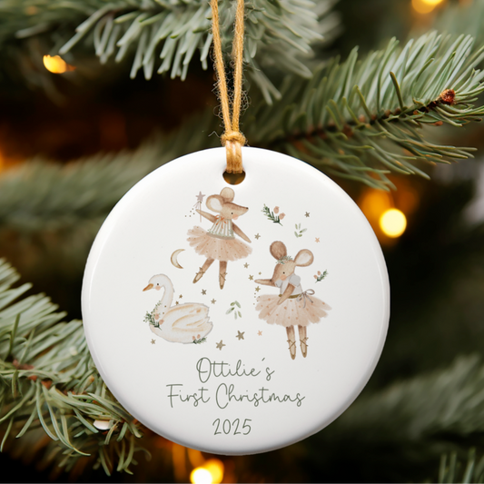 Decorative Christmas ornament with ballerina mouse design on a tree branch.