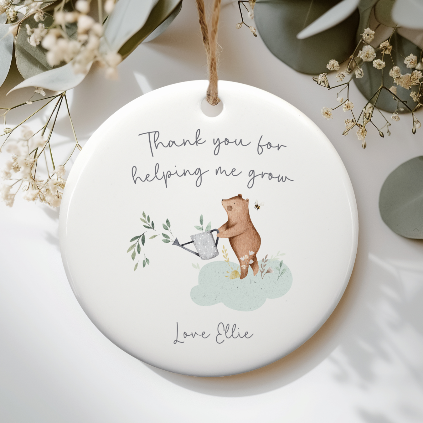 White ceramic ornament with cute bear with watering can illustration. Text includes "Thank you for helping me grow" and personalised with name.