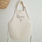 Off white linen-like personalised childs apron. Name in black text and cute heart doodle.