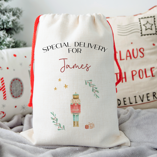 Personalized Christmas gift bag with 'Special Delivery for James' text and festive design of the Nutcracker