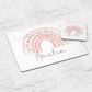White placemat and coaster set with pink floral rainbow. Personalised with name in script font.