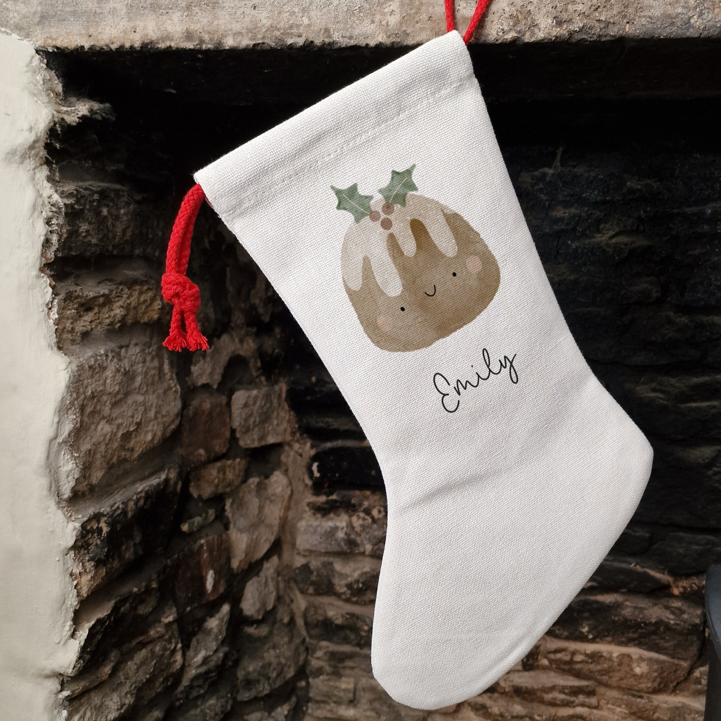 Off white linen-like stocking with cute Christmas pudding illustration, personalised with name in black script font.