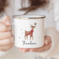 Person holding a mug with a reindeer design and 'Theodore' text.