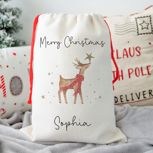 Off white linen-like santa sack. Magical reindeer illustration and personalised with name.