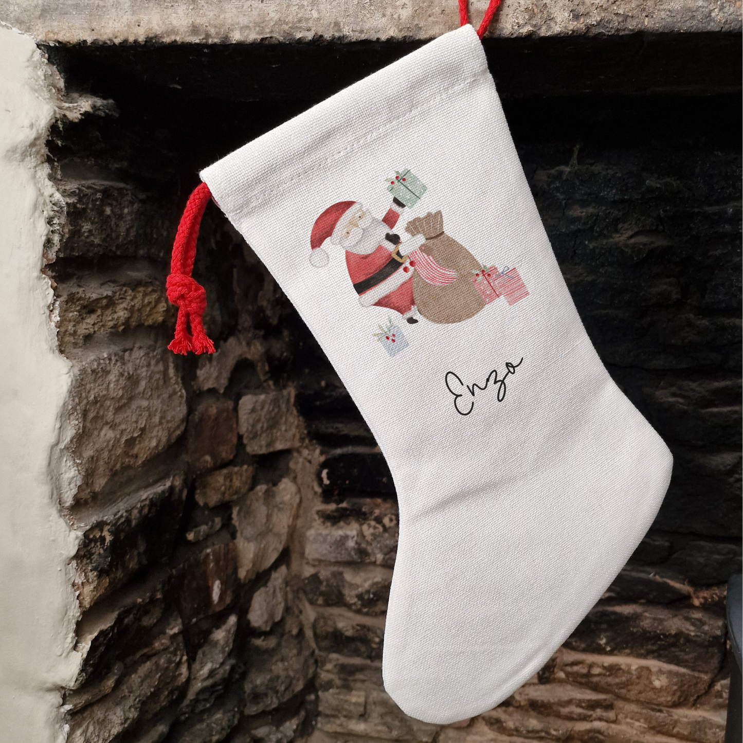 Off white linen-like stocking with cute Santa Claus llustration, personalised with name in black script font.