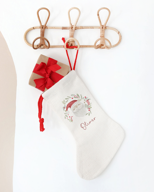 White Christmas stocking with Santa Claus design and 'Oliver' embroidery on a white background
