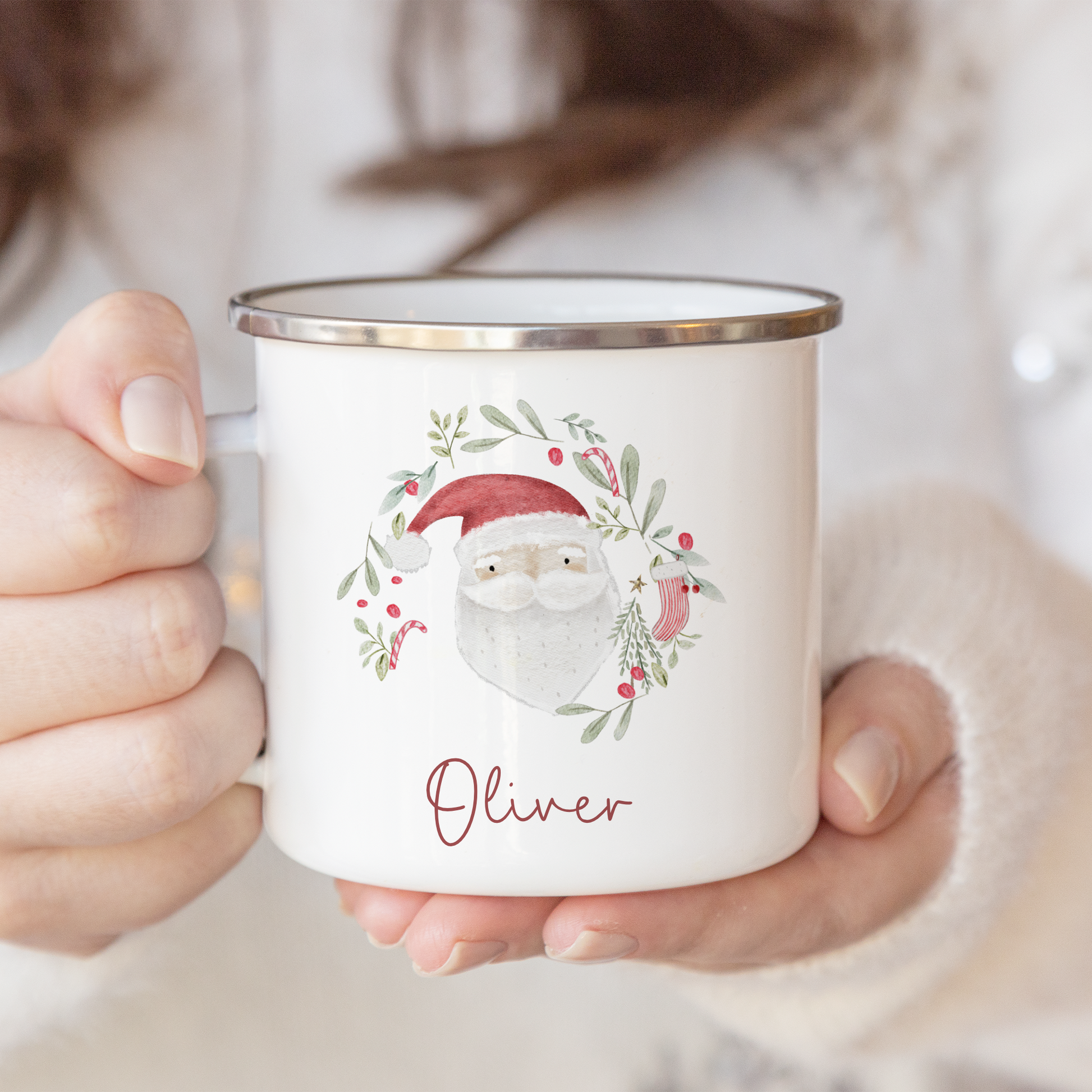 Person holding a mug with a Christmas-themed design and 'Oliver' text.